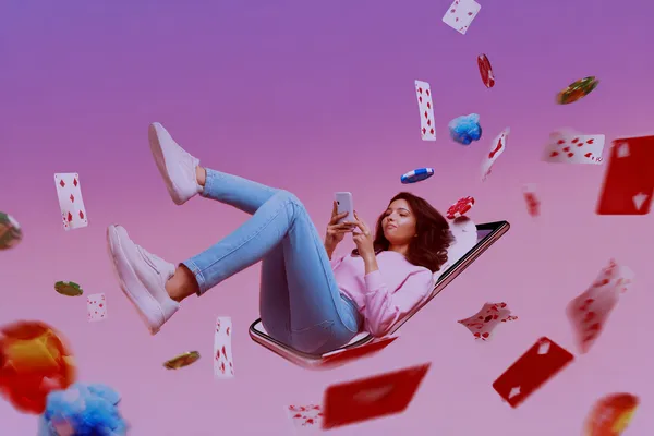 A young woman relaxing with her phone while dynamic casino elements float around her, illustrating the smooth mobile experience offered by the SPINARA app.